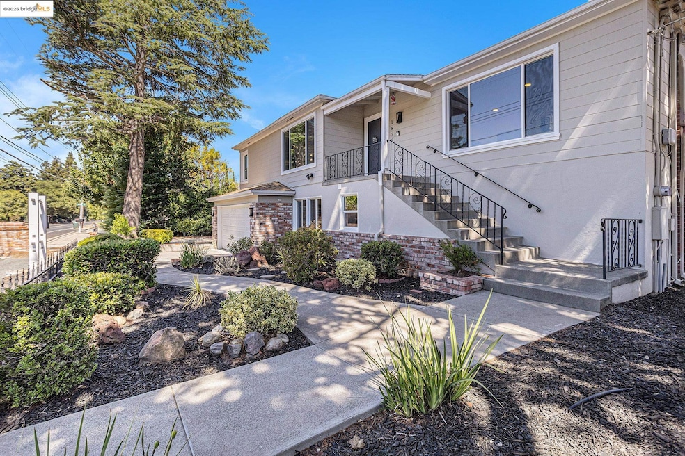 View of front of house featuring brick siding, stairway, and a garage