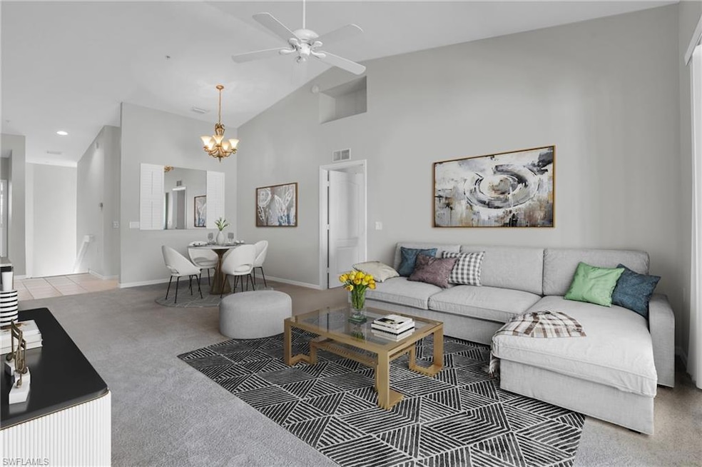 Living room with ceiling fan with notable chandeli