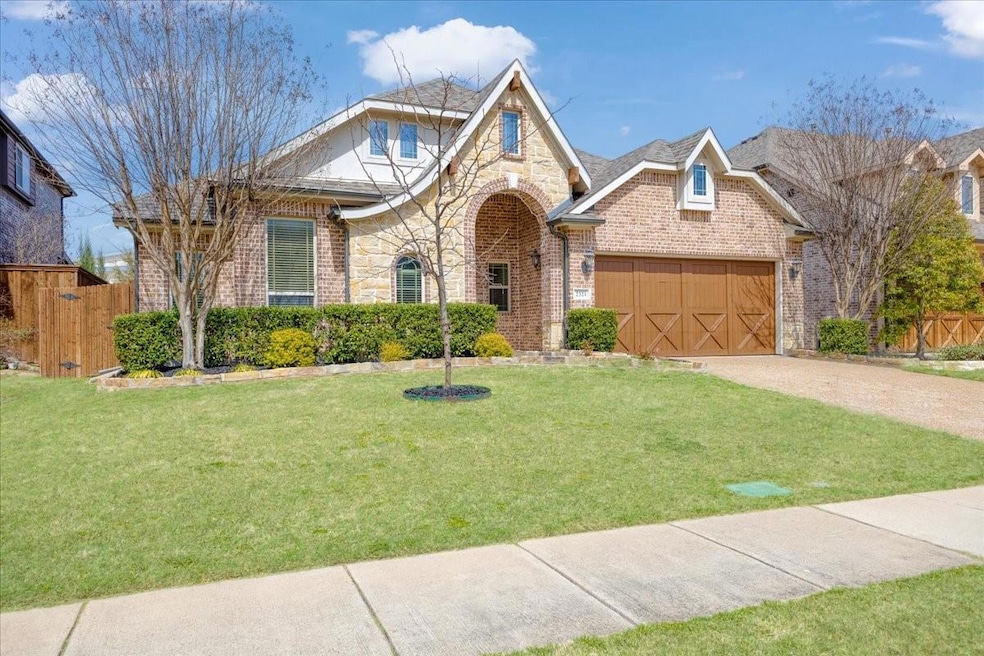 View of front of house featuring fence, a front la