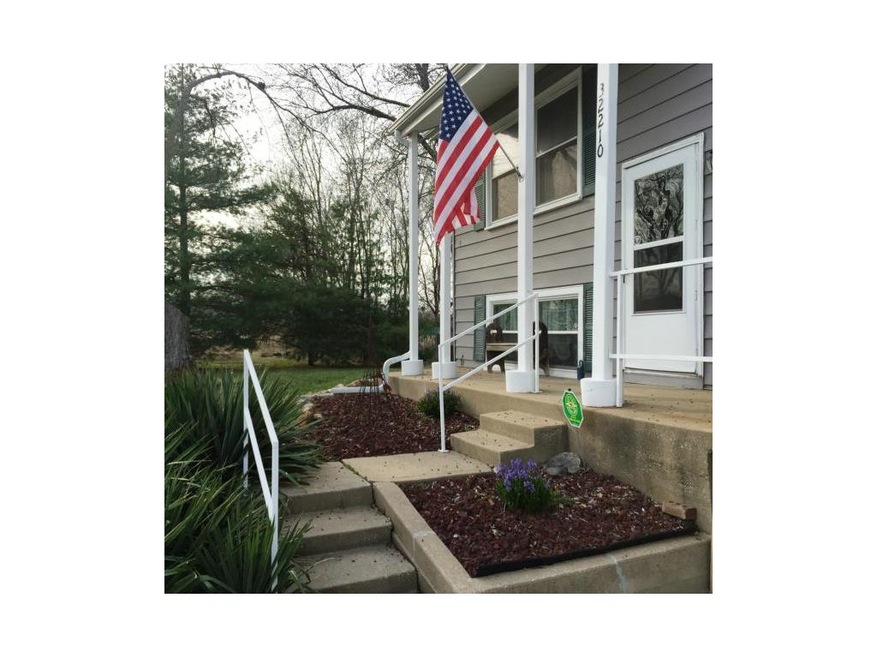 Cute front porch is so welcoming with spring flowe