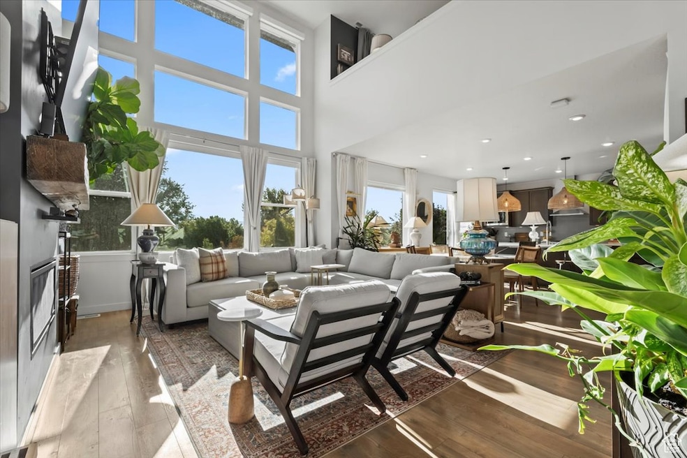 Living area with wood finished floors and a towering ceiling