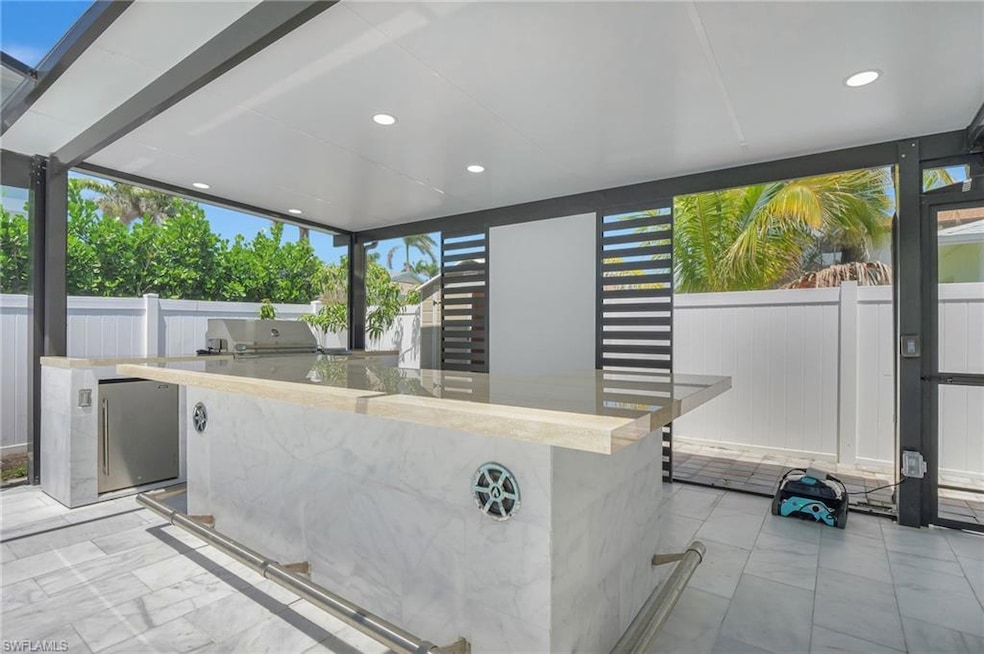 Custom covered outdoor Kitchen with Built in Bar a