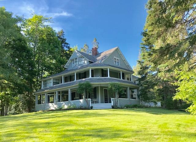 Sweeping front lawn to cottage entrance.