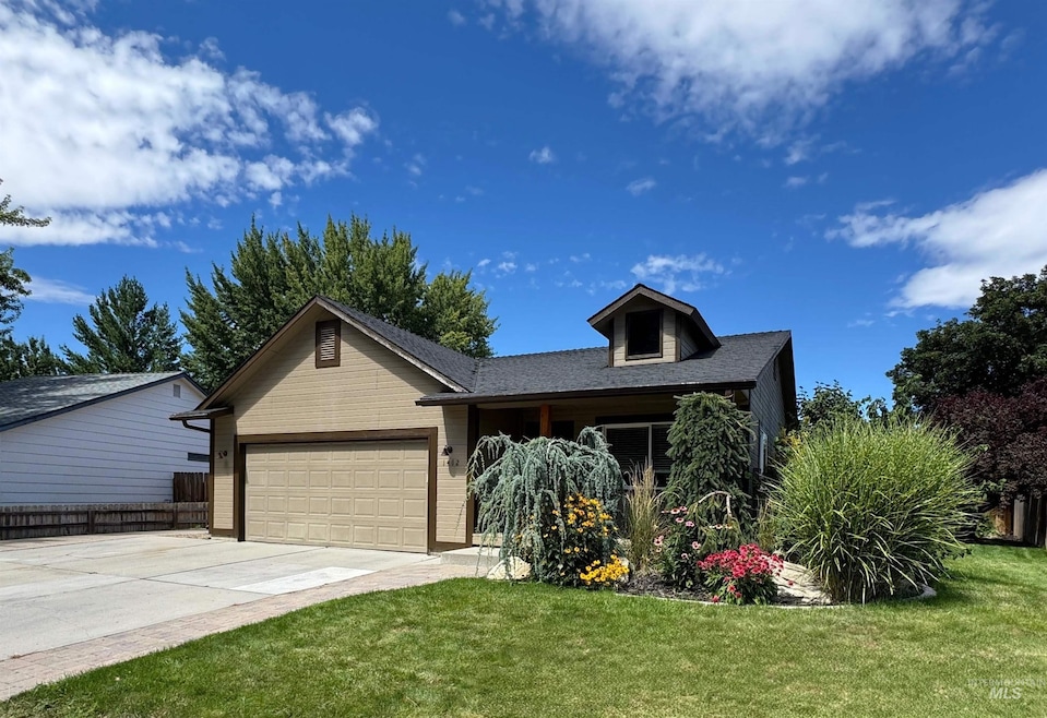 View of front facade with concrete driveway, an attached garage, and a front yard