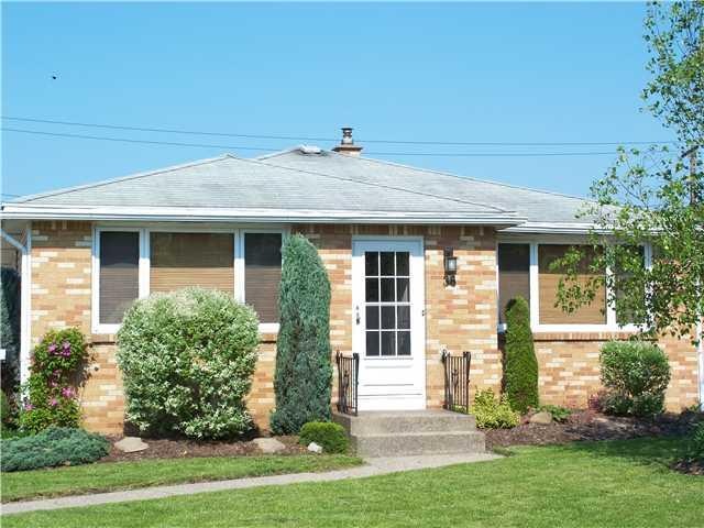 Exterior Front. Brick front, concrete driveway and