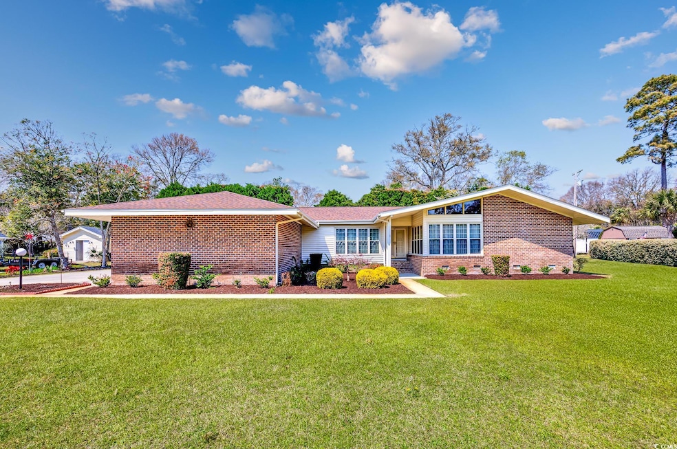 View of front of home with brick siding, roof with
