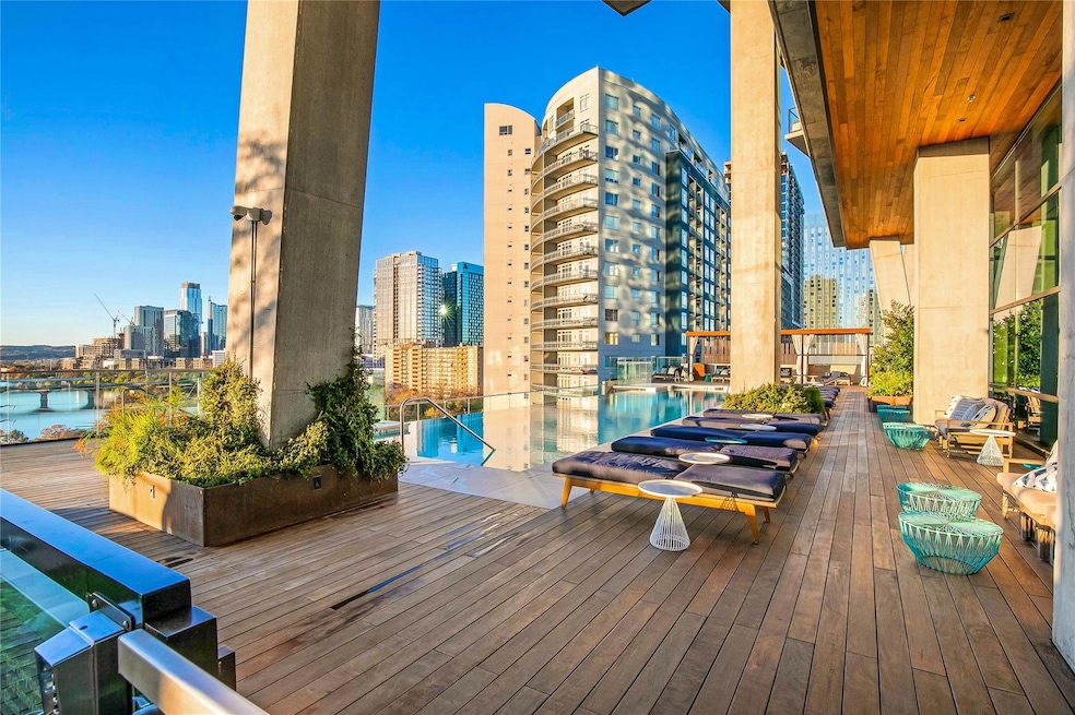 Wooden deck featuring a water view and a city view