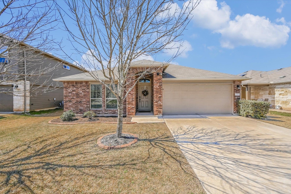Ranch-style home featuring a shingled roof, concr