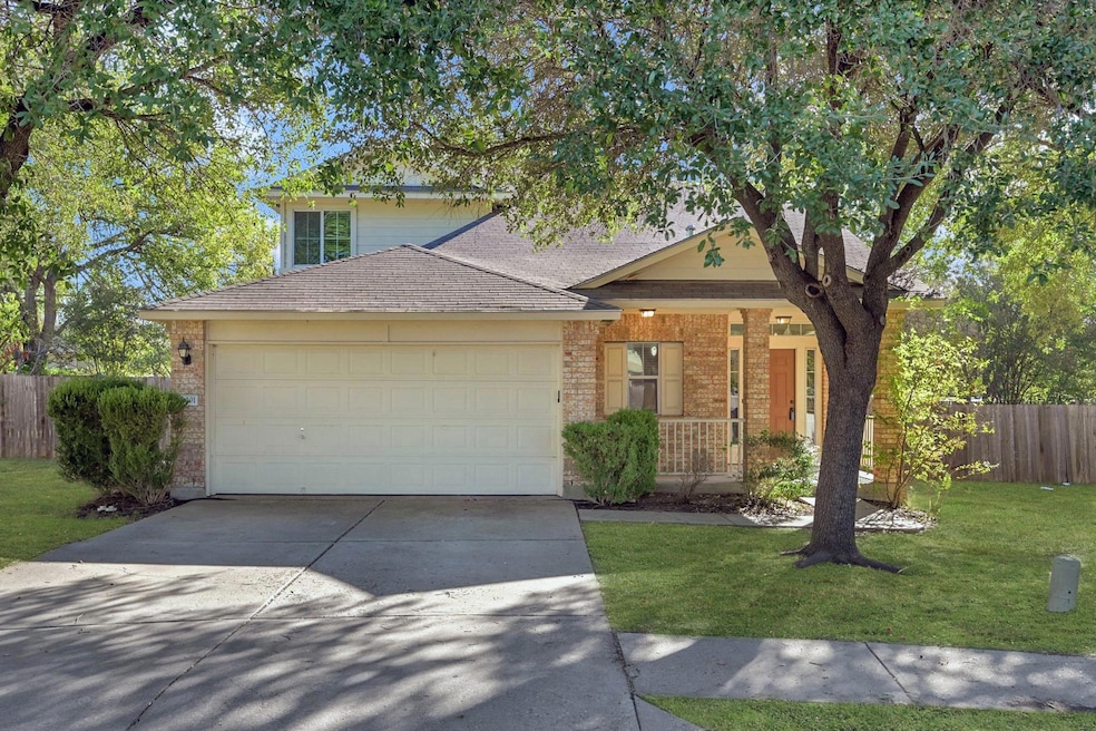 View of front of house featuring a porch, driveway, an attached garage, and roof with shingles