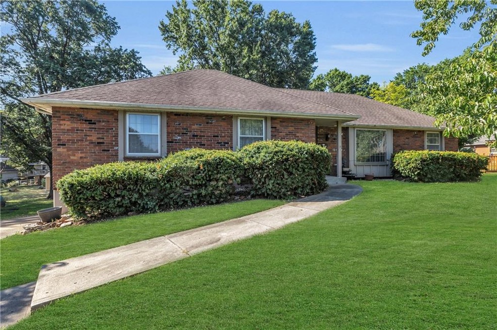 Ranch-style home featuring a front lawn