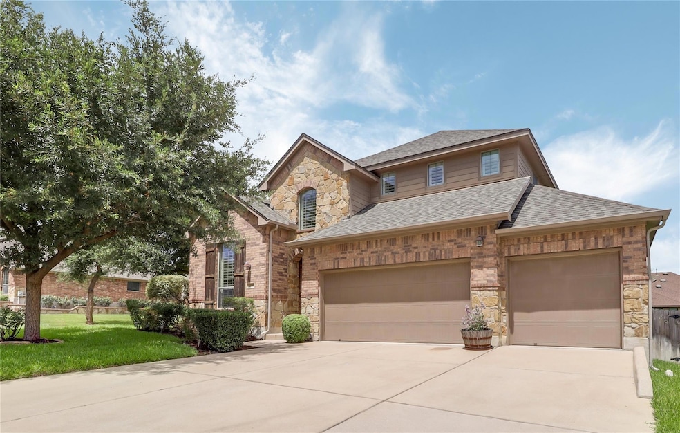 View of front of home with stone siding, roof wit