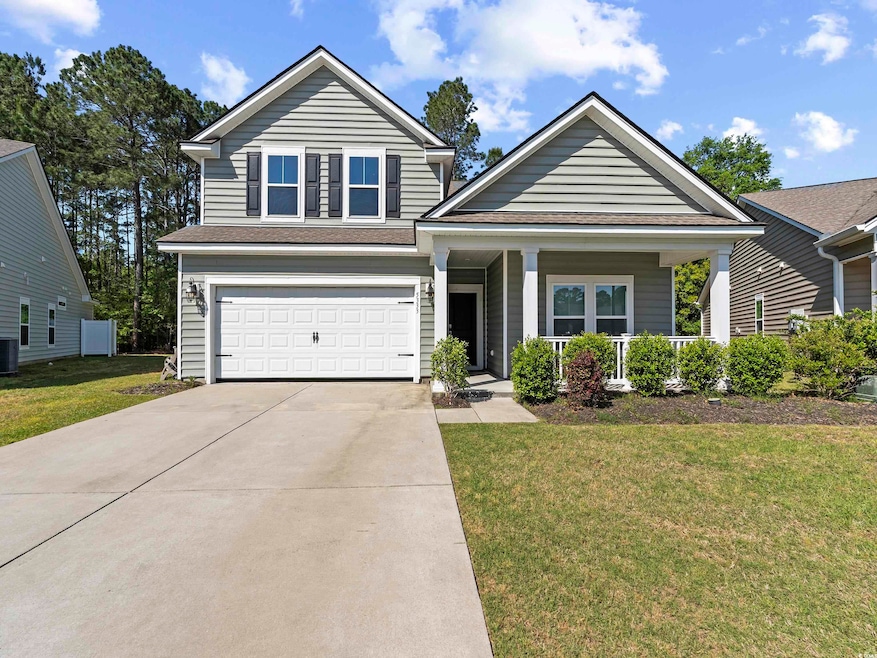 Traditional home featuring an attached garage, cov