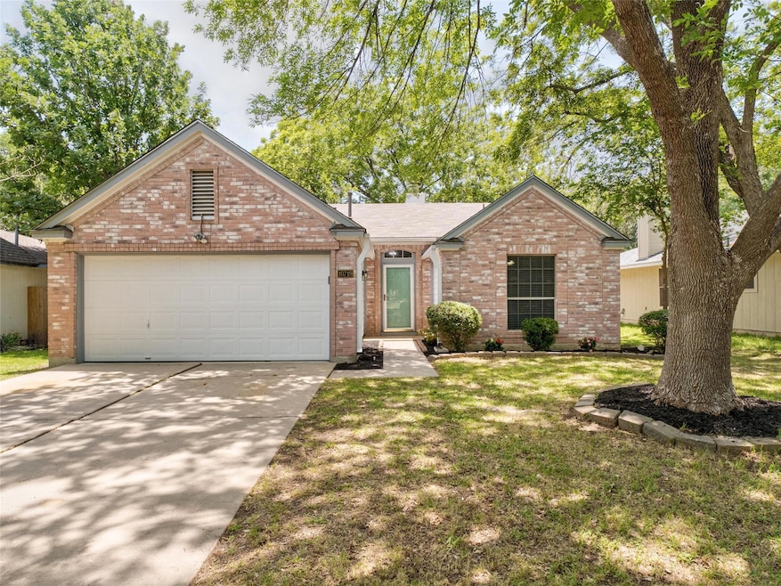 Single story home with brick siding, an attached 