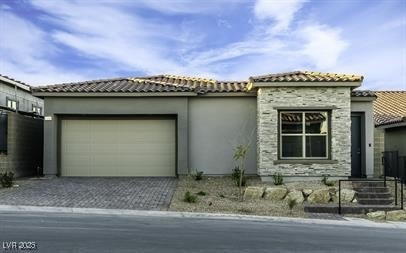 View of front of home featuring a tile roof, an at