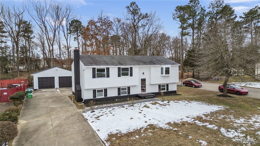 Raised ranch with a garage and an outbuilding