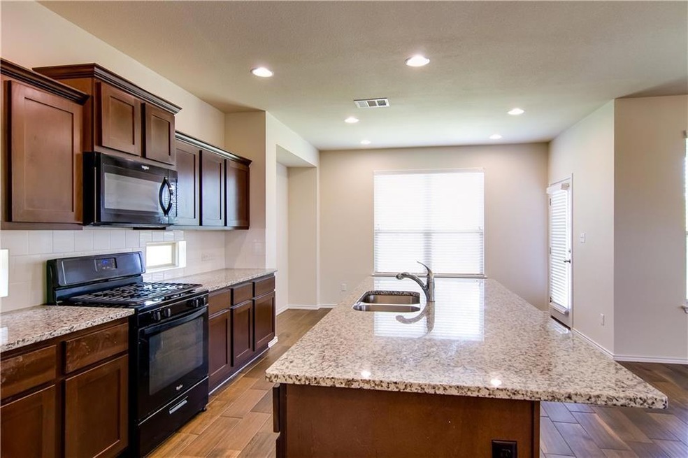 Kitchen featuring visible vents, black appliances