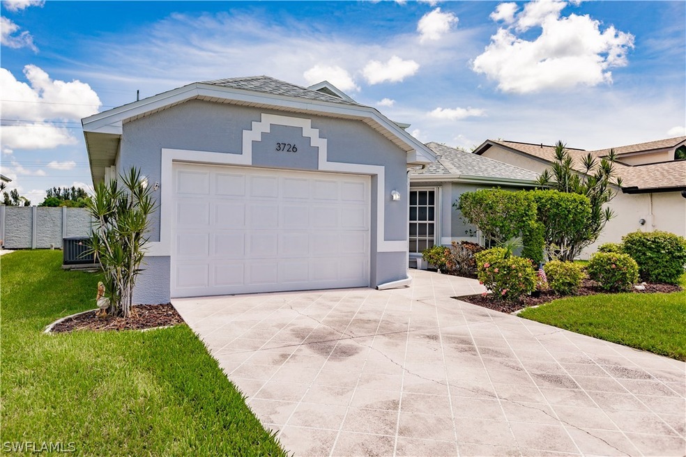 Ranch-style home featuring central AC unit, a gara