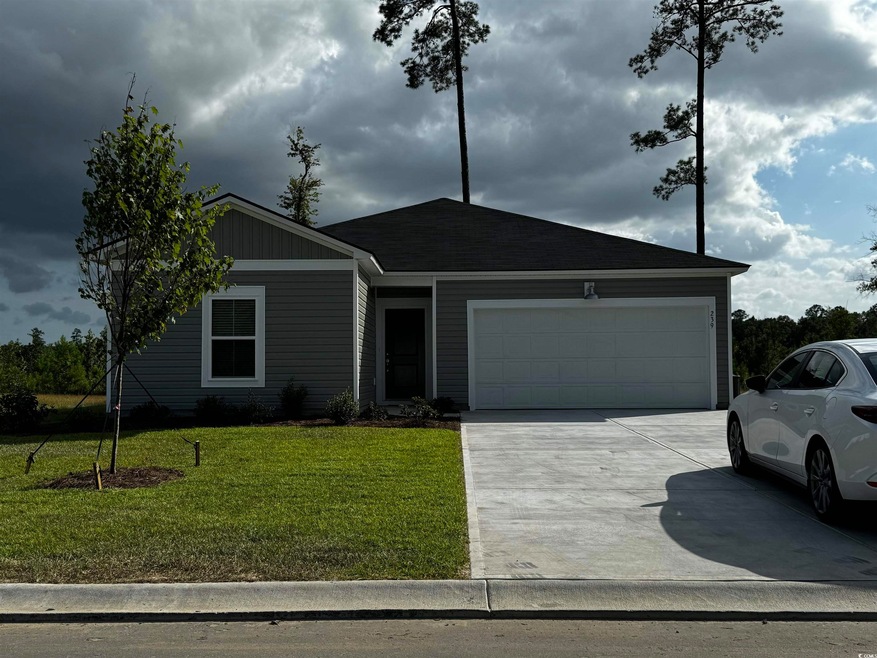 Ranch-style house featuring a garage and a front l