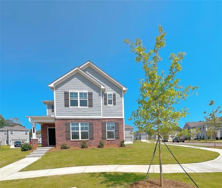 View of front of property featuring brick siding and a front lawn