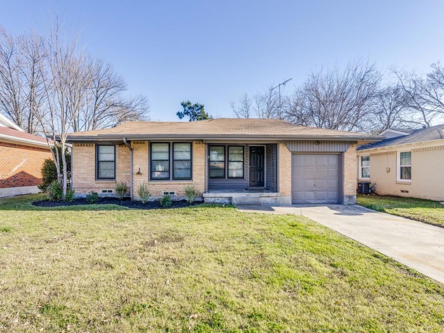 Single story home with a garage, a front lawn, and