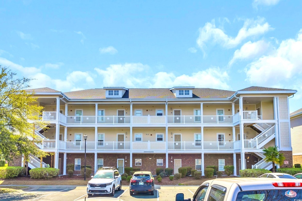 View of property featuring uncovered parking