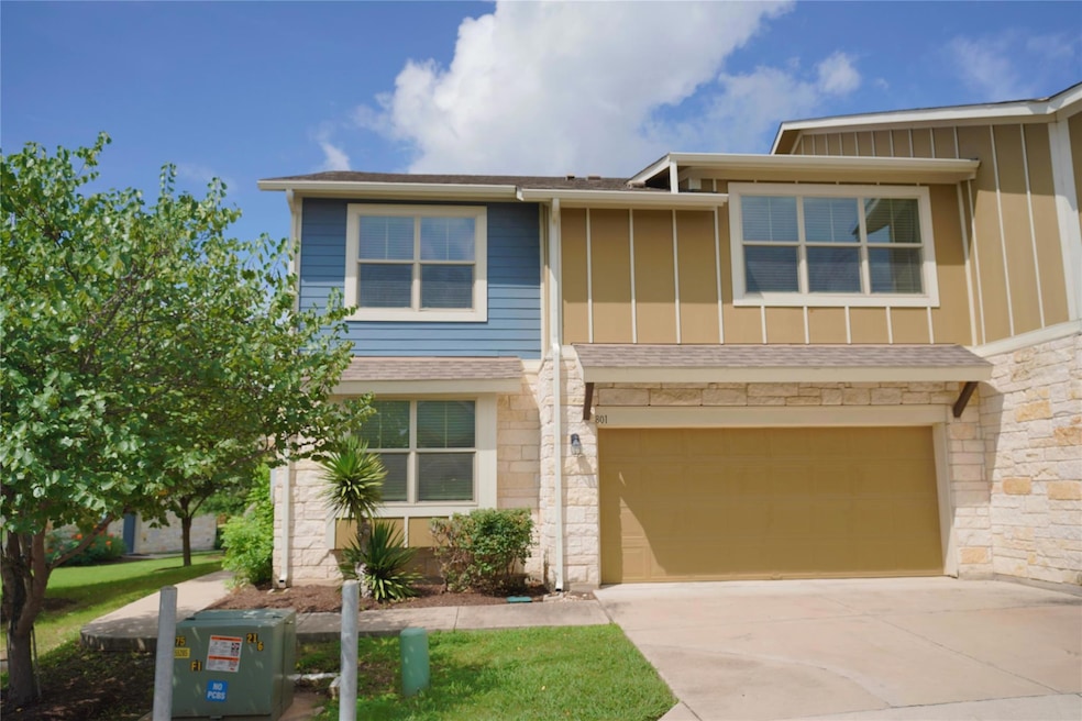 View of front of property with stone siding, driv