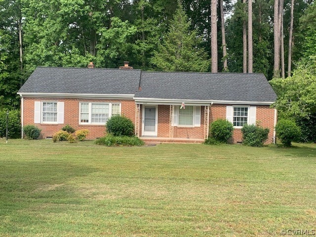 Single story home featuring a front yard