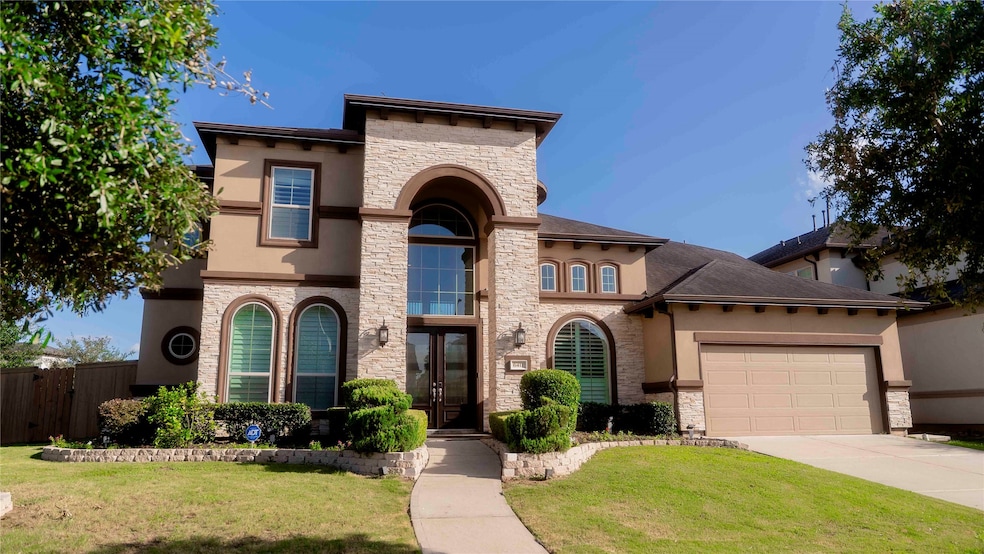 Striking curb appeal with stone accents and a gran