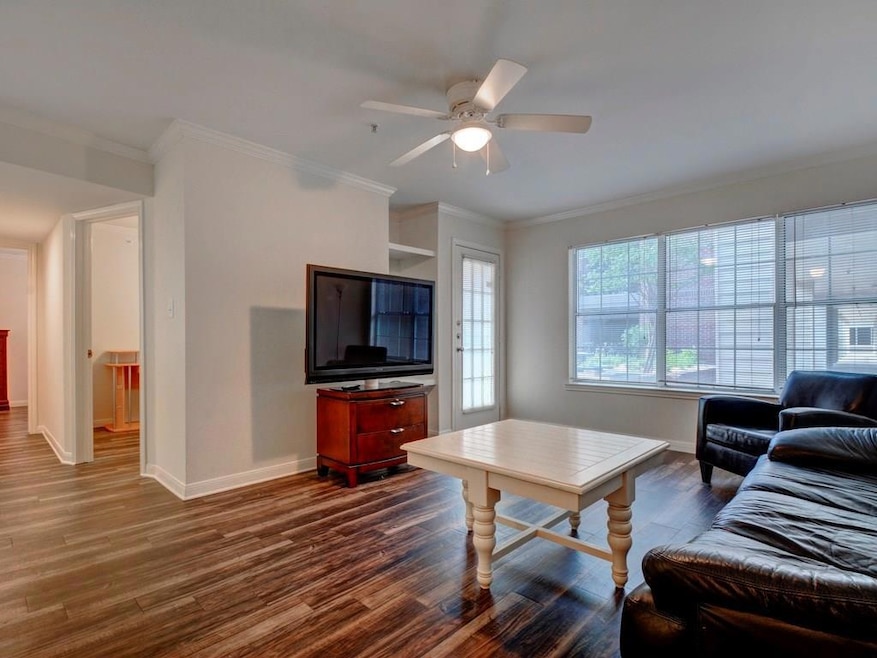 Living area featuring baseboards, dark wood finis