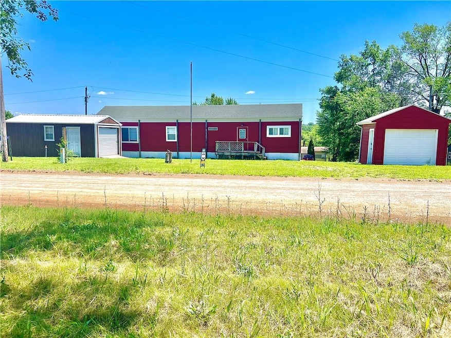 View of front of property with a garage and an outbuilding
