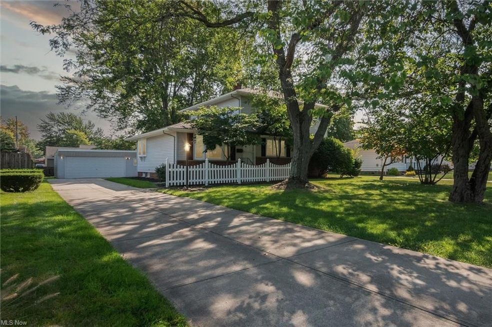 View of front of home with garage and a lawn