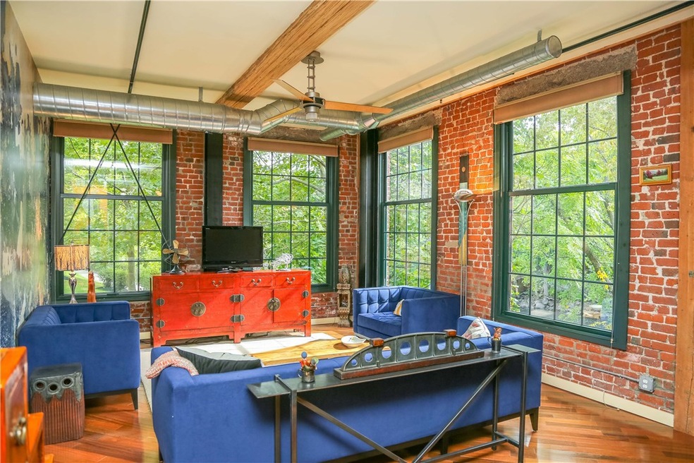 Come home to this light filled, exposed brick, riv