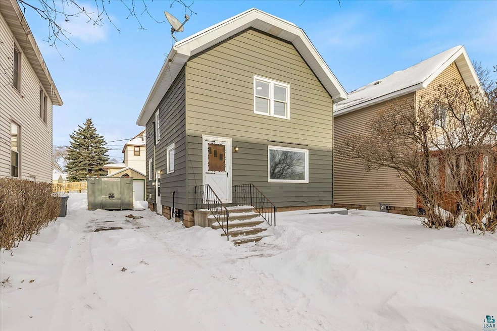 Front of the House with a driveway along side it.