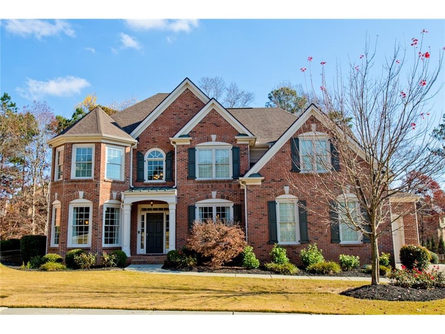 3 sided brick home with 3 car garage