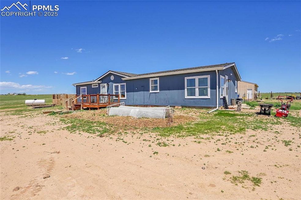 Rear view of house with a wooden deck