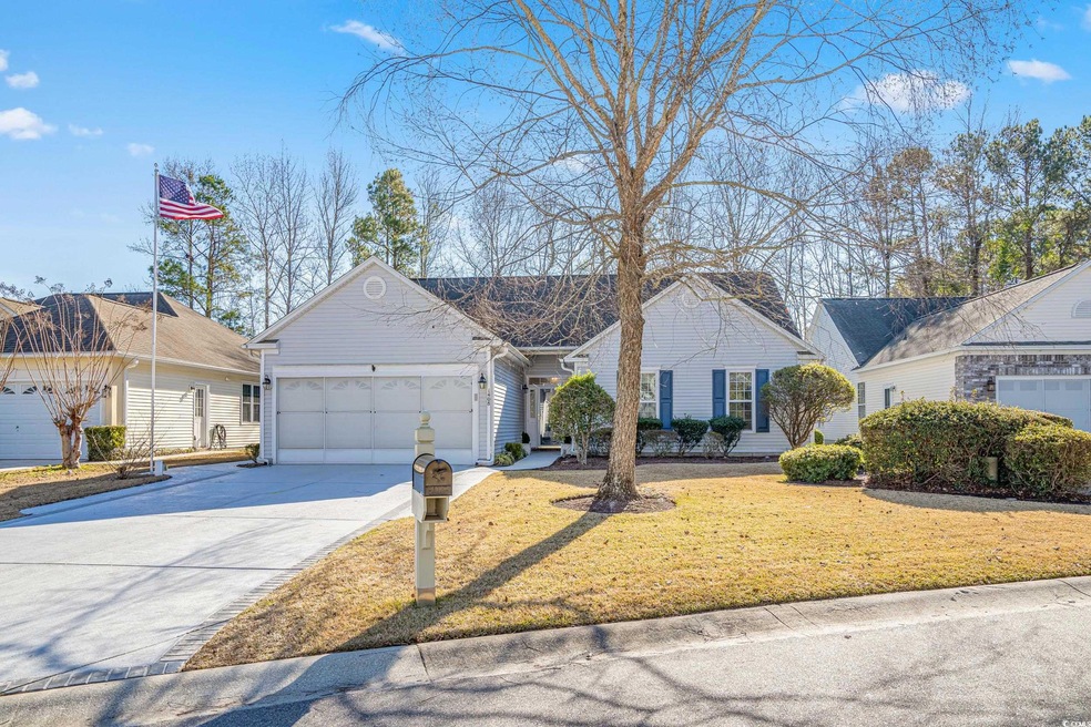 Ranch-style home with a front lawn and a garage