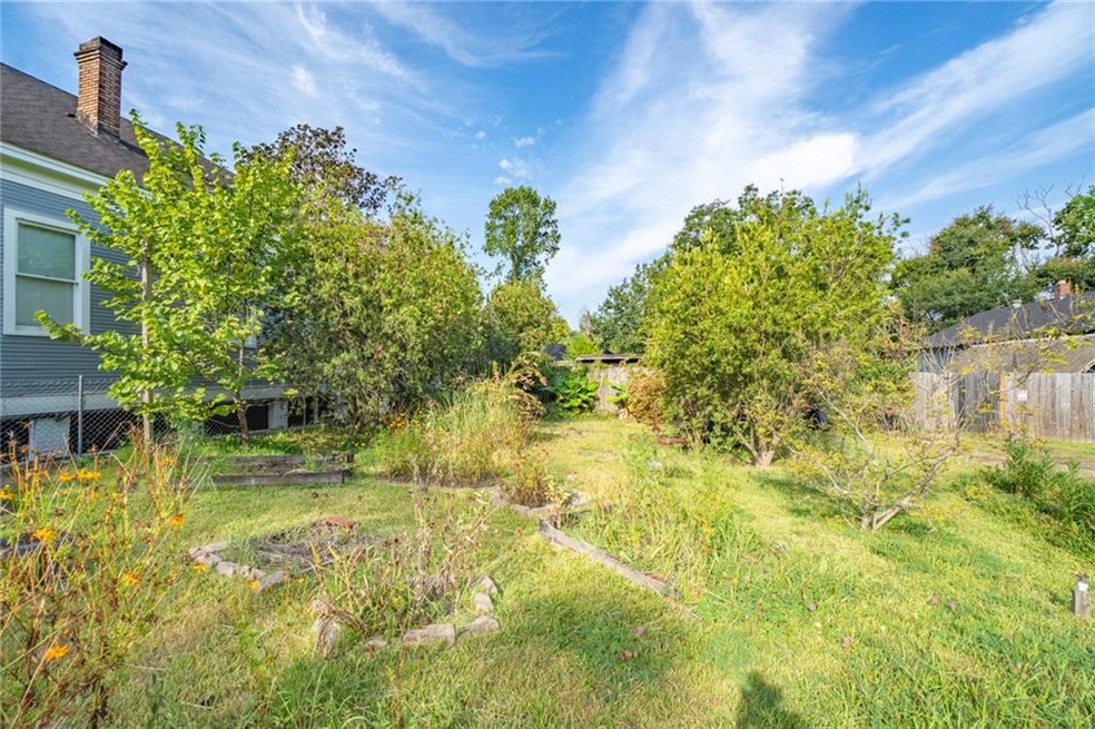 Front of property features raised beds and mature 
