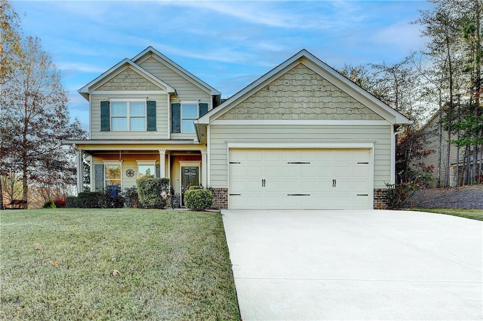 Craftsman-style house with an attached garage, dri