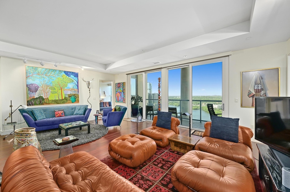 Living area with wood finished floors, a raised c
