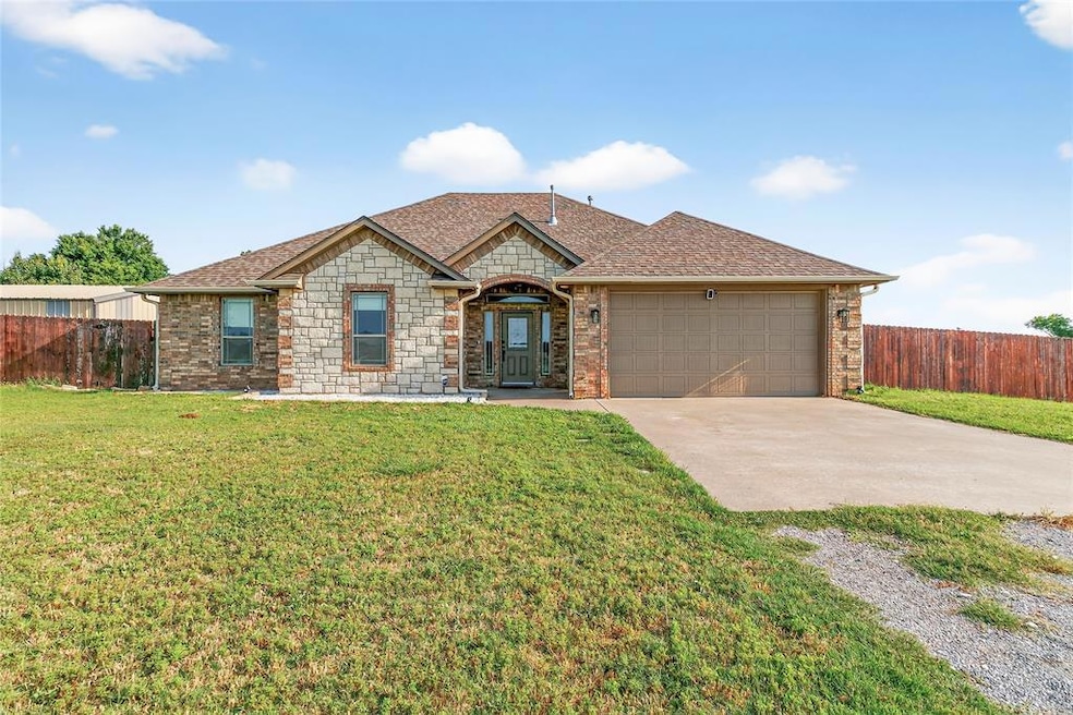 View of front of house featuring concrete driveway, an attached garage, a shingled roof, and stone siding