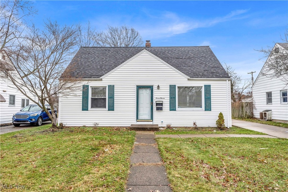 Bungalow-style home featuring central AC unit and a front yard