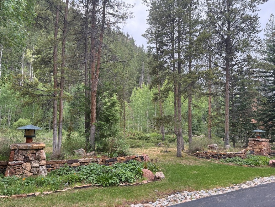 Driveway for lot is marked by stone entry structur