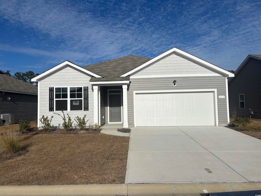Ranch-style home featuring a garage and driveway