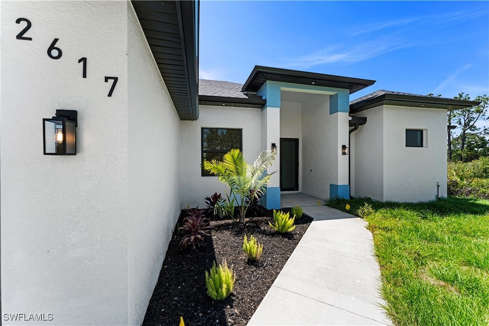 Entrance to property with stucco siding