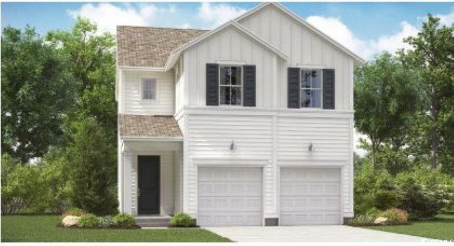 View of front of property featuring concrete drive