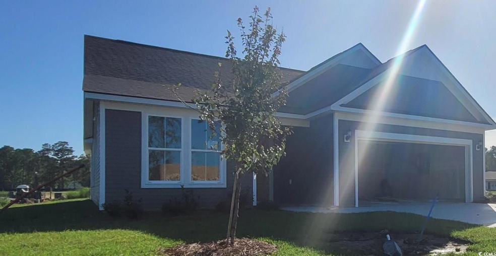 View of front of house with a garage and a front y
