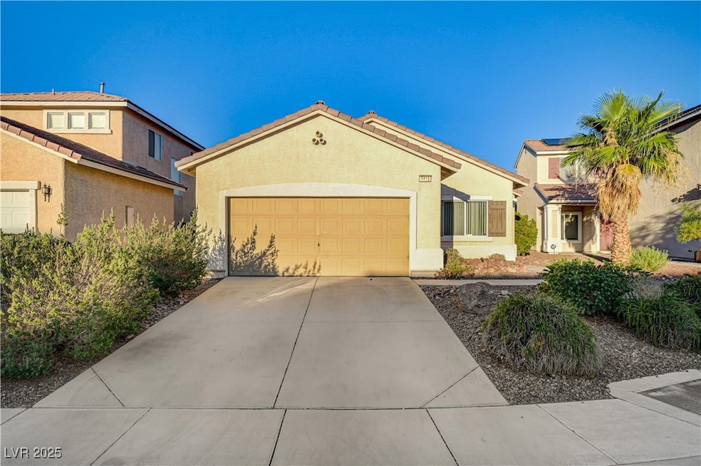 View of front of home with a garage, concrete driv