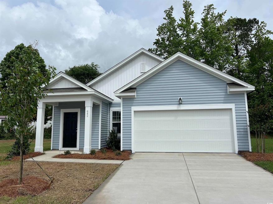 View of front of property featuring concrete drive