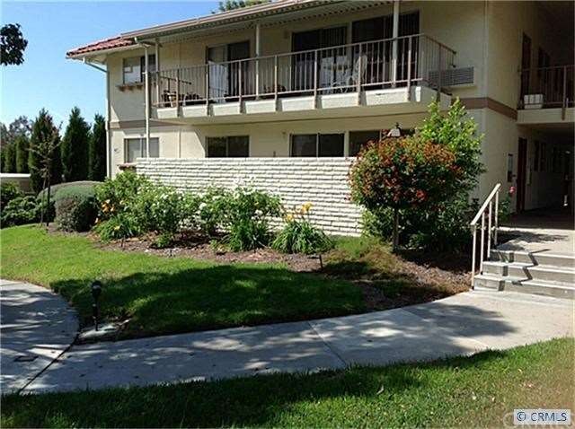 Front with enclosed patio overlooking greenbelt