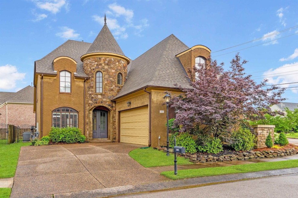 French country style house with concrete driveway, roof with shingles, an attached garage, french doors, and brick siding